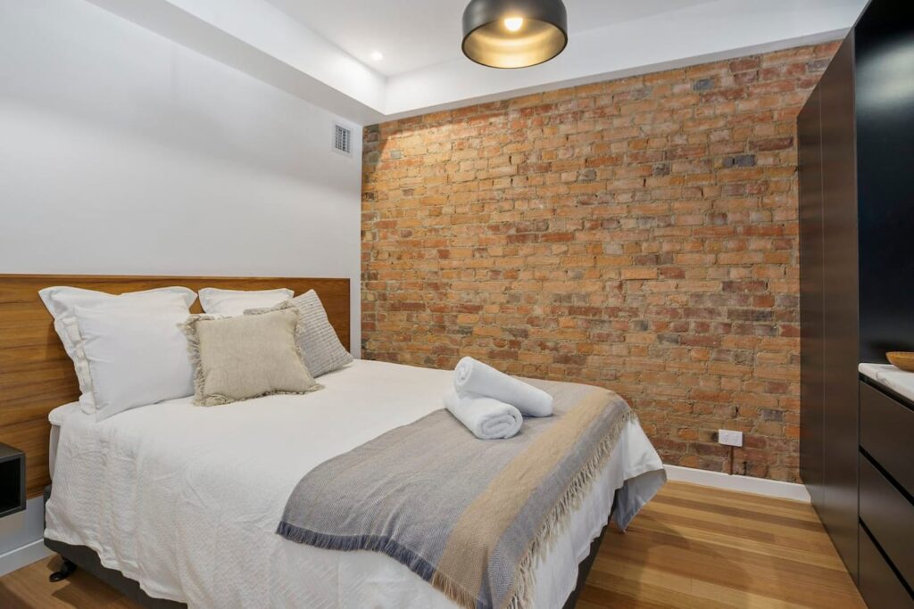 Bedroom area with brick wall behind